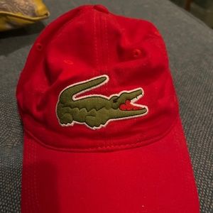 A red men’s or women’s Lacoste hat